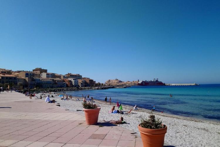 Vue sur la plage et la ville de l'île-Rousse lors d’un transfert privé VTC depuis l’aéroport de Bastia